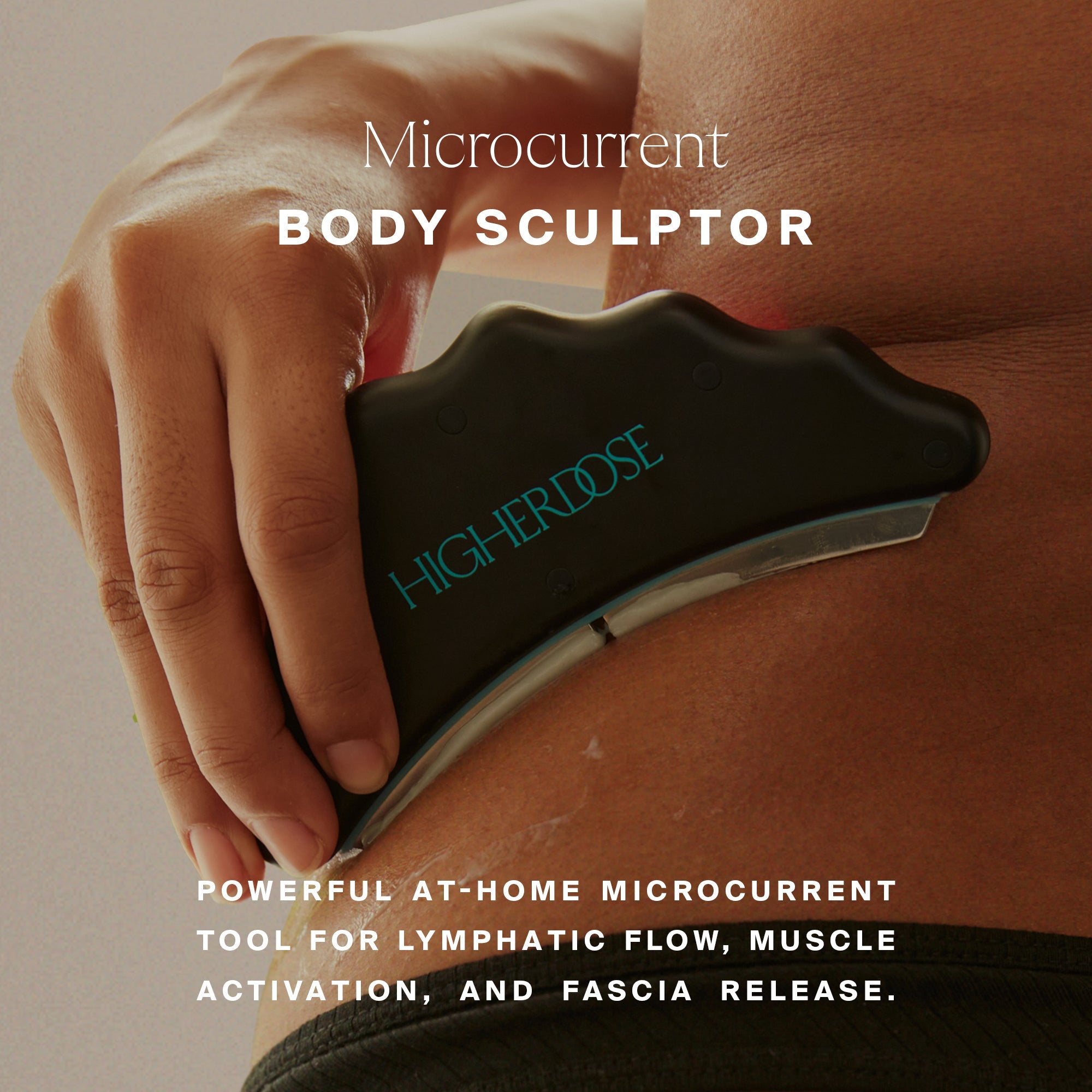 Hand holding black Microcurrent Body Sculptor device