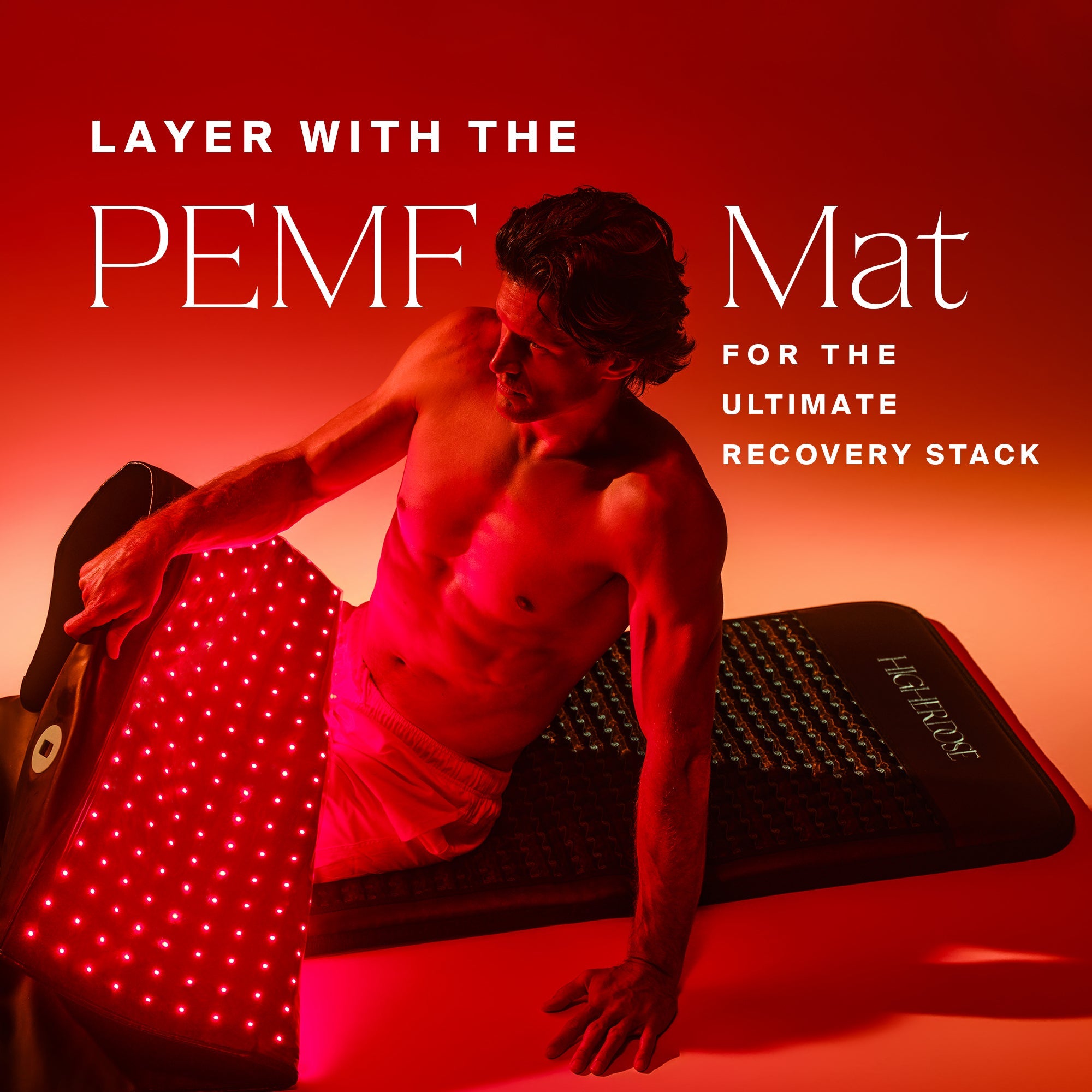 Shirtless man positioned over two stacked Full Body Red Light Mats