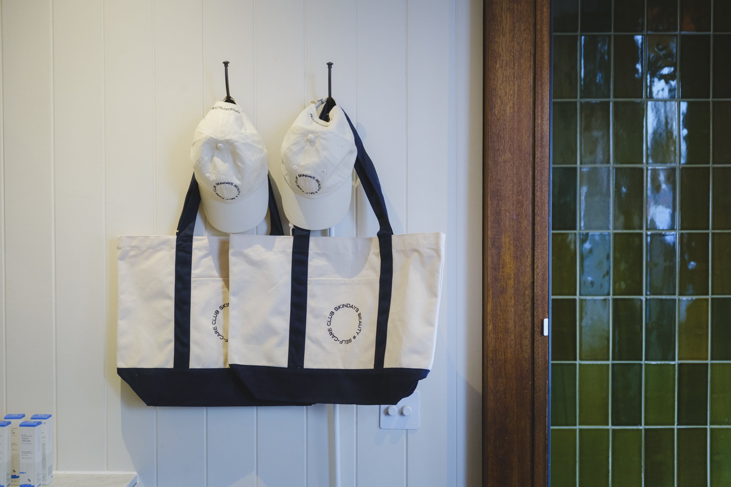 Skindays canvas tote bag with navy handles and embroidered Skindays Beauty & Self-Care Club logo