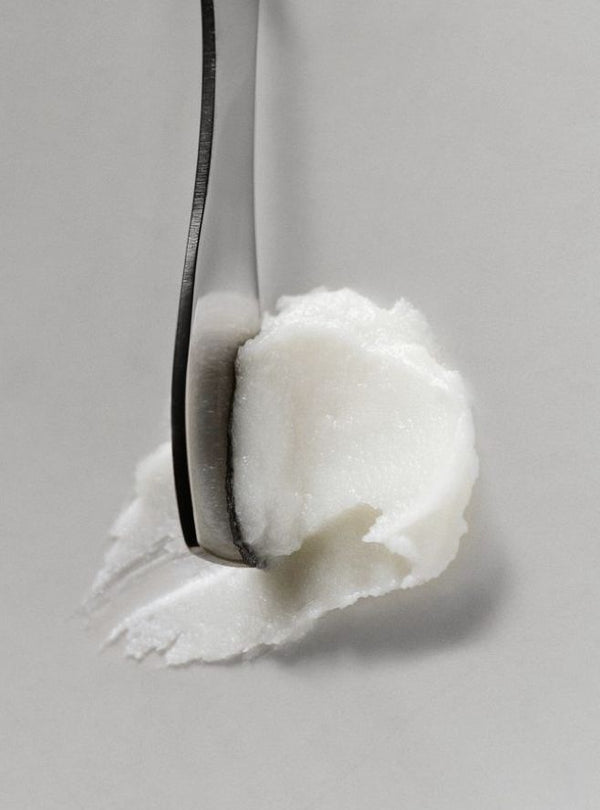 A white balm texture on the edge of a spoon